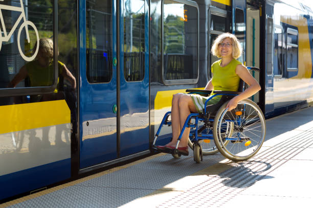 woman sitting on wheelchair on a platform stock photo