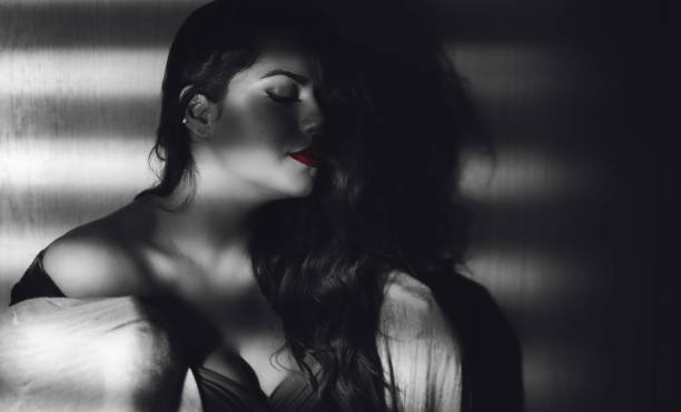 istock Young seductive woman under blinder shadow 1199620463