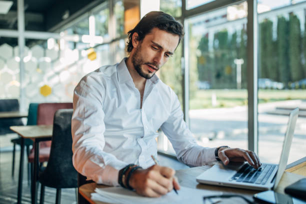 istock Man working on laptop in cafe 1199620665
