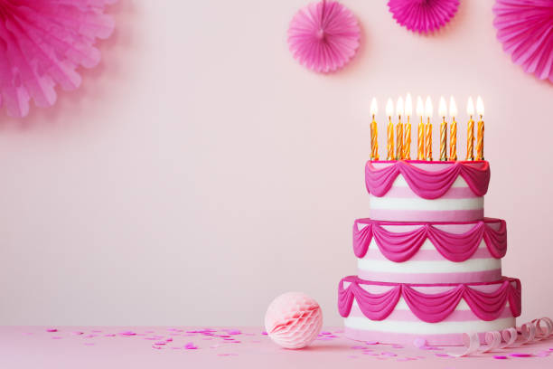 istock Birthday party with pink tiered cake 1199621042