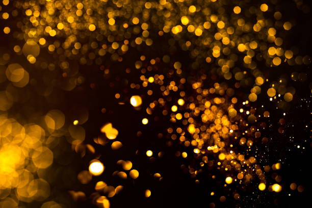 istock Golden abstract bokeh on black background. 1199621274