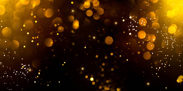 istock Golden abstract bokeh on black background. 1199621275