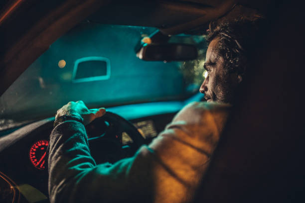 istock Businessman Driving A Car In Night 1199621441