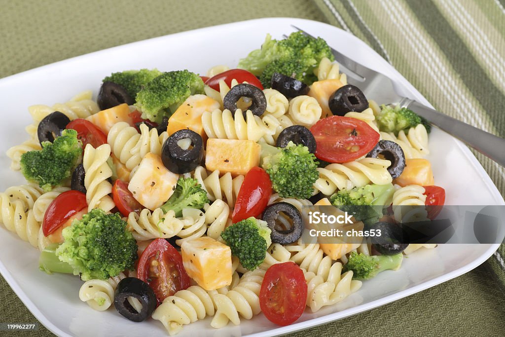 Pasta Salad Pasta salad with cheese, tomatoes, black olives and broccoli Black Olive Stock Photo