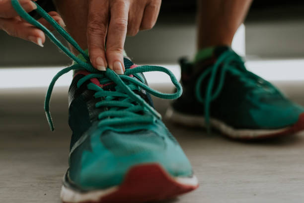 istock runner tying his shoe to do sports 1199624891