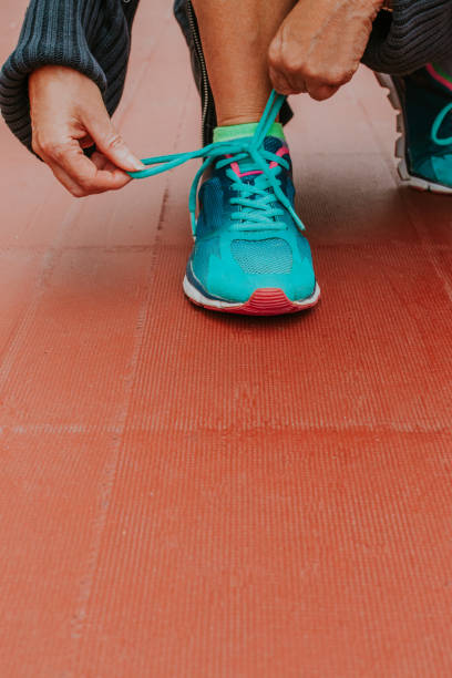 istock closeup of hands tying the running shoe 1199624903