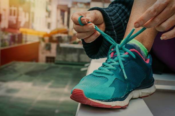 istock closeup of hands tying the running shoe 1199624921
