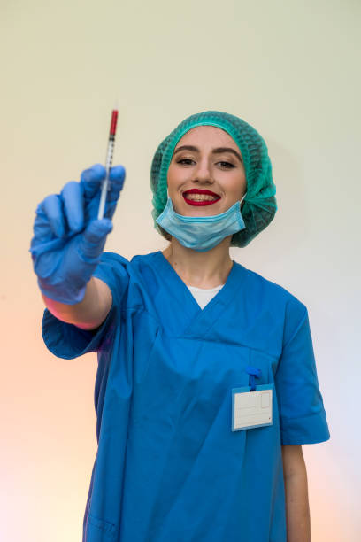 attractive nurse with syringe getting ready for injection. medical theme - surgical glove human hand holding capsule imagens e fotografias de stock