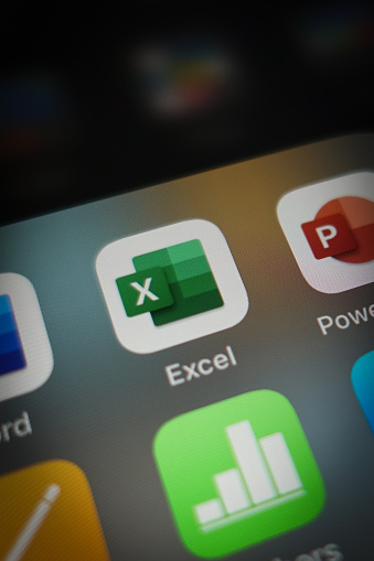 Italy, Rome - January 15 2020: The icon of the Excel app for iOS surrounded by some other office applications such as: Numbers (competitor app) and Power Point. Excel is part of office 365 suite.