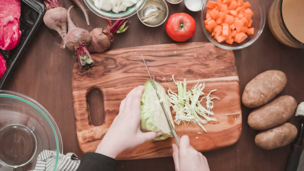 istock Shredding green cabbage for beet soup, borscht. 1199632565