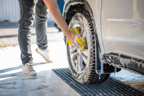 istock man hand holding yellow sponge cleaning car 1199633958