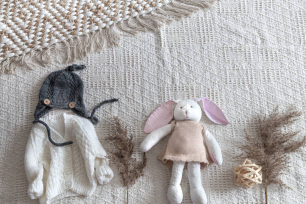 istock Knitted children's clothing on a light background with accessories 1199634266