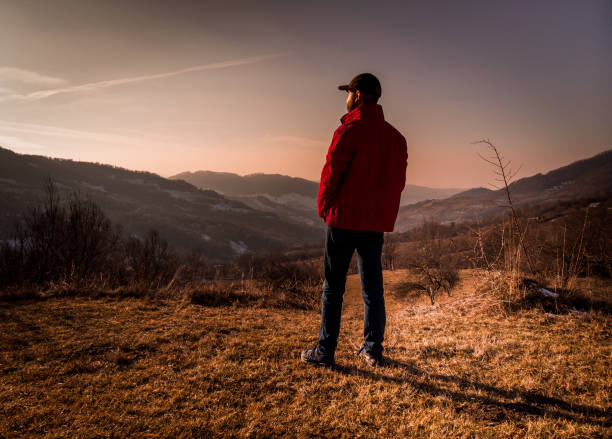 istock Independent man alone looking at view in mountain landscape 1199636396