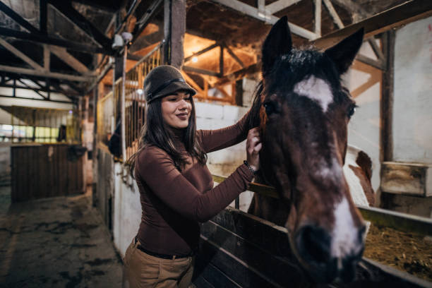 istock Jockey in barn with her horse 1199636828