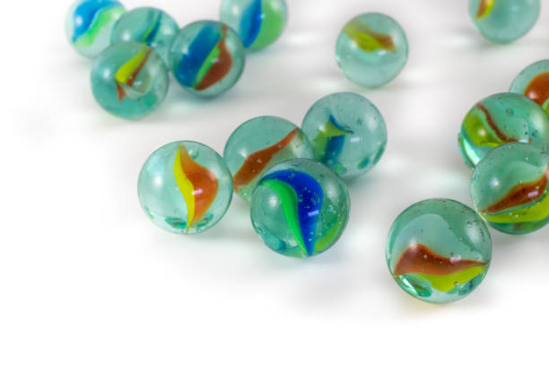 istock Scattered marble balls on white background. Selective focus. Copy space for text. Colorful marbles balls. Entartaining toys for kids. 1199638533