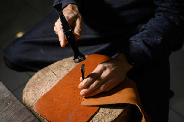 istock Leather Craftsman works at the tanner shop 1199640086