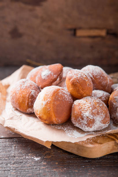 istock Bunuelos de viento - traditional Colombian sweet deep fried pastry. Spanish Easter doughnut. Mexican golden, crispy-sweet, tortilla-like fritters are sprinkled with sugar 1199642334