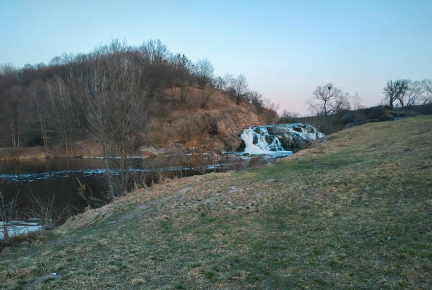 Water rushing over rocks in a small waterfall at sunset