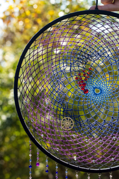 istock Handmade dream catcher with feathers threads and beads rope hanging 1199643282