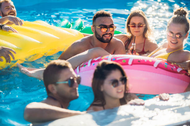 istock Friends at a poolside party 1199644420