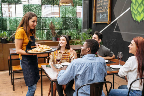 istock Young waitress delivering empanadas to smiling customers 1199644438