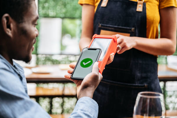 istock Restaurant customer making mobile payment with smart phone 1199644452