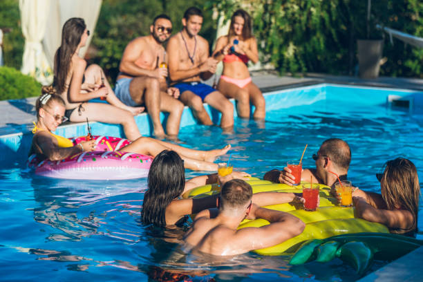 istock Friends at a poolside party 1199644844