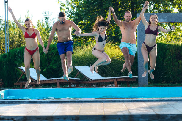 istock Friends jumping in swimming pool 1199644991