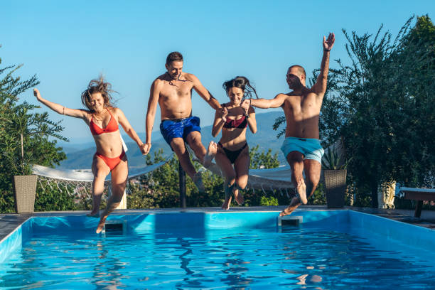 istock Friends jumping in swimming pool 1199645517