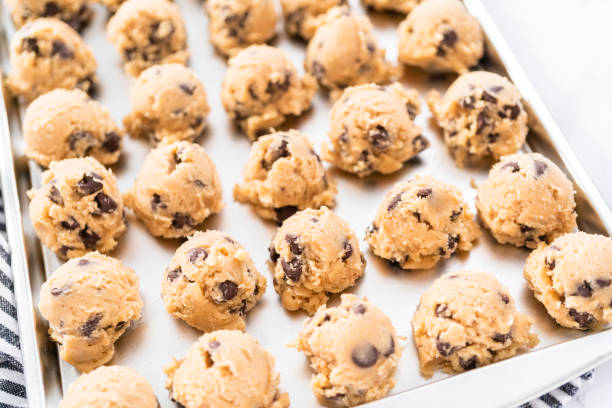 istock Homemade chocolate chip cookies dough scoops on a baking sheet. 1199645537