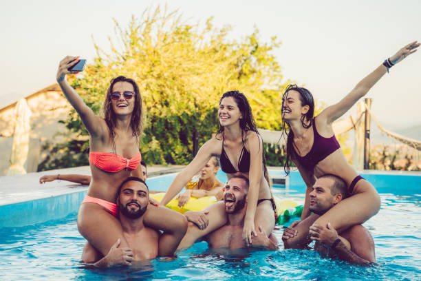 istock Selfie with friends at a poolside party 1199646237