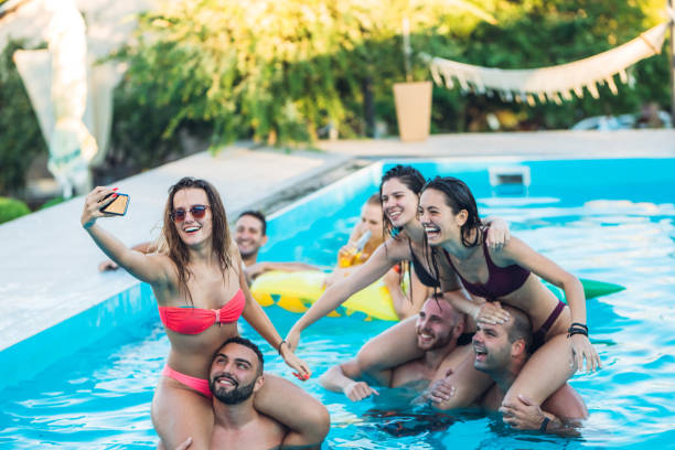 istock Selfie with friends at a poolside party 1199646275