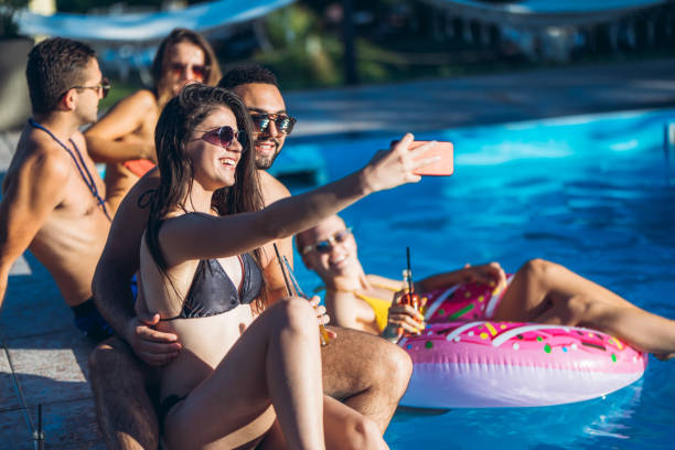 istock Selfie with friends at a poolside party 1199646302