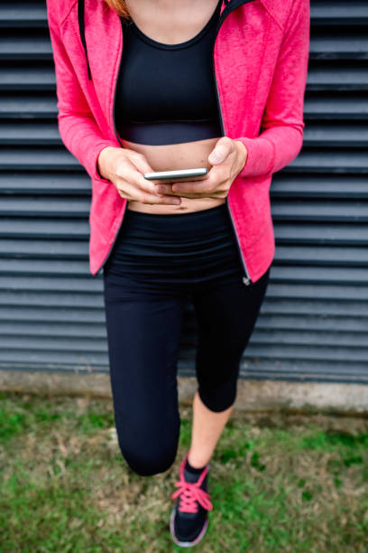 istock Unrecognizable female athlete with mobile phone 1199647237