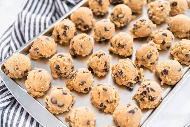 istock Homemade chocolate chip cookies dough scoops on a baking sheet. 1199647251