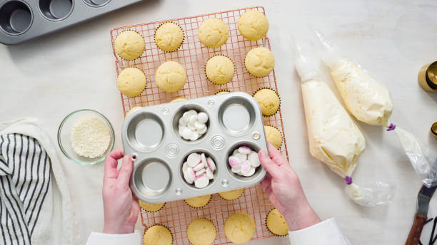 istock Decorating vanilla cupcakes with white buttercream frosting for Easter. 1199647256