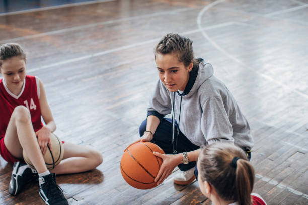 istock Female coach with basketball team 1199648576