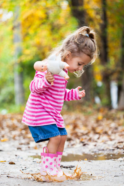 istock little girl playing in poddle 1199650273