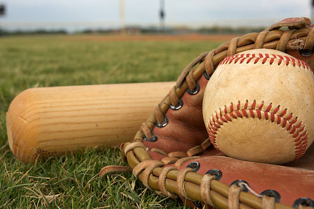 istock Baseball in a glove with bat 119965232