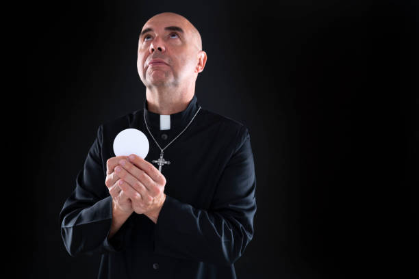 istock Priest holding communion wafer in eucharist 1199653625