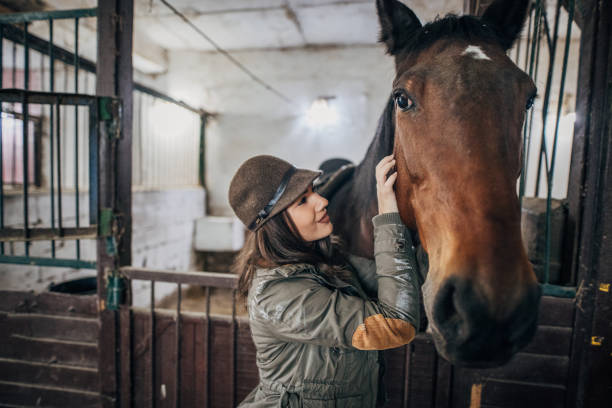 istock Pretty woman in barn with horse 1199656803