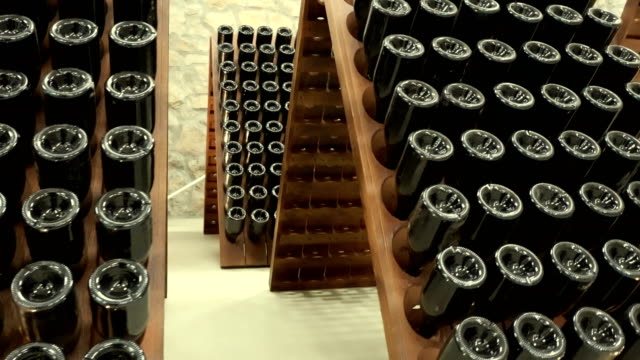 stacked of old wine bottles in the cellar