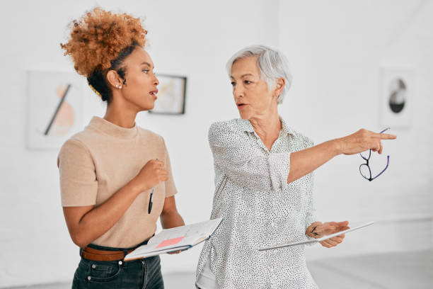 This is where the new department could go Shot of two businesswomen having a discussion in a modern office delegating stock pictures, royalty-free photos & images
