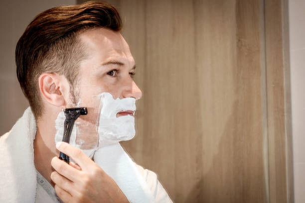 istock Man shaving with razor in the bathroom. 1199659294