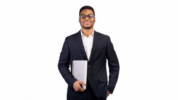 istock Serious black man holding laptop on white background 1199661089