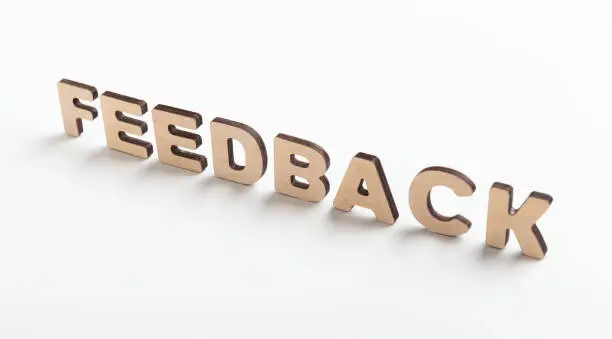 Photo of Word feedback of wooden letters on white background