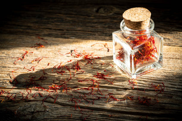 istock Saffron spice in glass bottle on rustic wooden table 1199662528