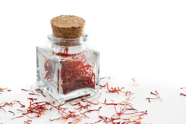 istock Saffron spice in glass bottle isolated on white 1199662828