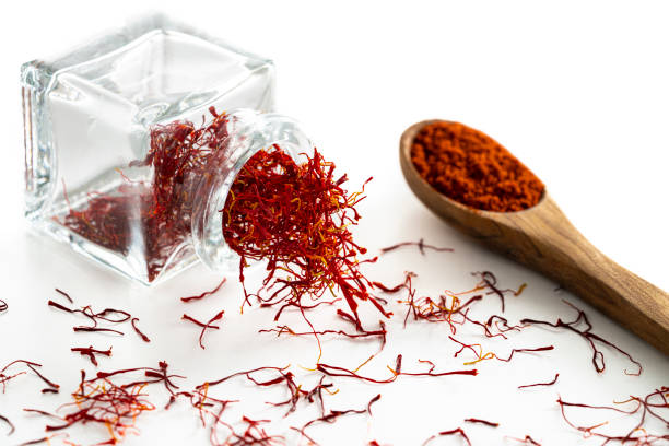 istock Saffron spice in glass bottle isolated on white 1199662864