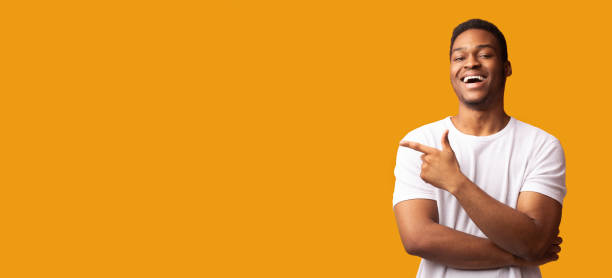 istock African american man pointing aside at empty space 1199663063